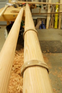 Steam-bent wood strips around joint in mast